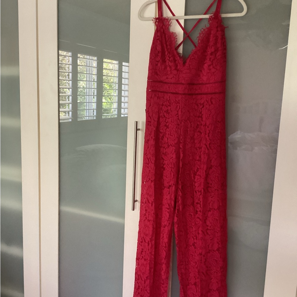 NWT Bebe lace jumpsuit nwt. Legs are see through showing underneath shorts